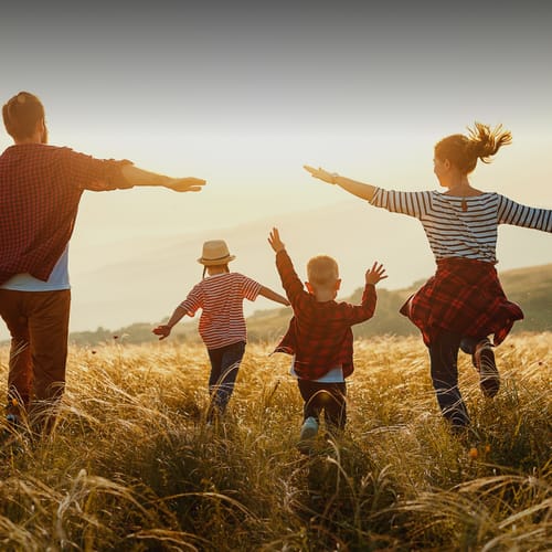 Family running through a field