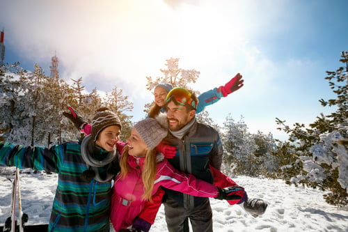 Happy family enjoying winter vacations in mountains